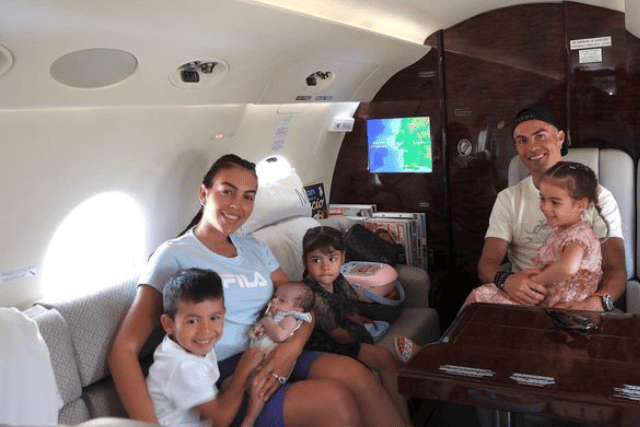 Cristiano Ronaldo and his girlfriend, accompanied by their children, share a private jet moment, epitomizing family elegance at new heights. 