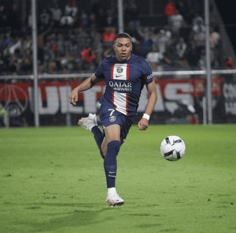 Kylian Mbappe showcases lightning speed, gracefully running with the ball, a blur of skill and agility on the football pitch.